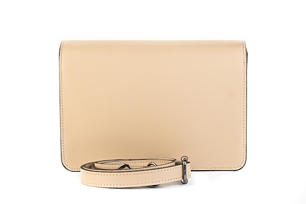 白い背景のミニマリストの財布のハンドバッグに分離されたベージュの革のバッグ