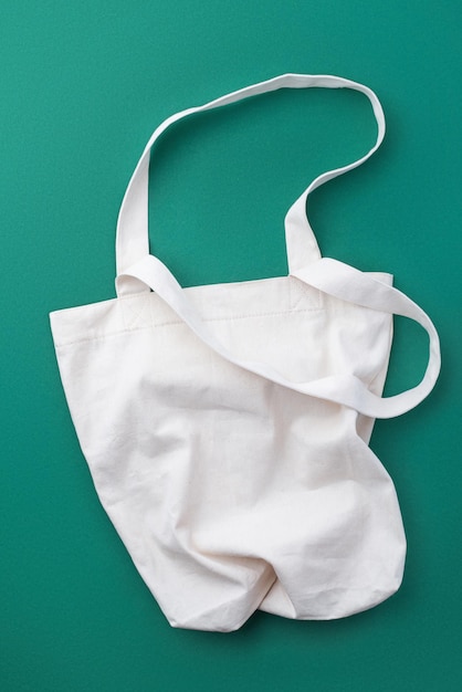 Beige linen eco bag on a green background