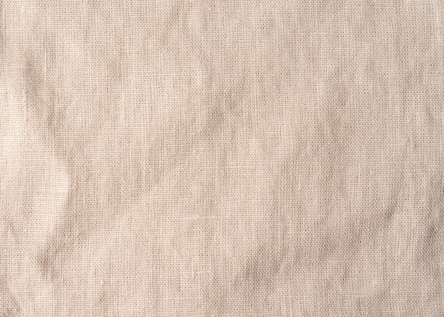 Beige napkin cloth texture. Linen fabric surface tablecloth background.