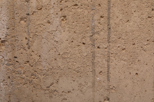 A beige old uneven plastered wall