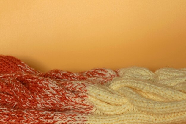 Beige and orange knitted clothes on an orange background
beautiful knitting gradient copy space flat lay top view