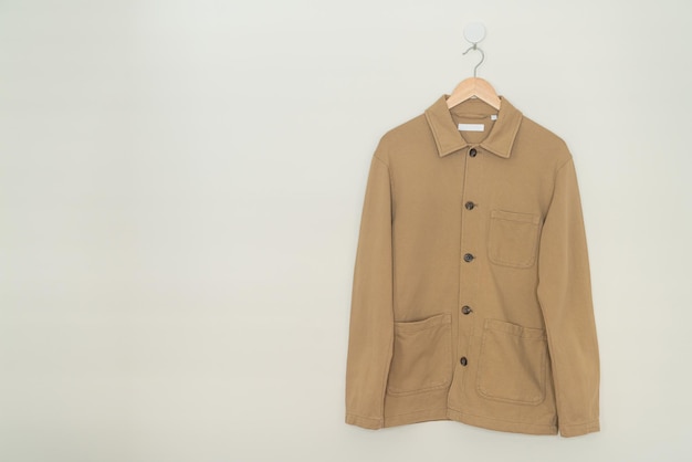 beige pak hangend met houten hanger