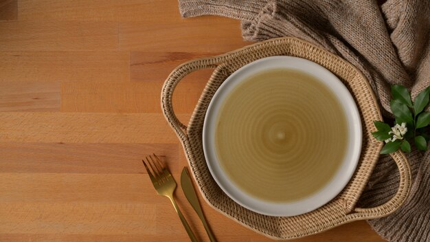 Beige plate with a cloth on a wooden table