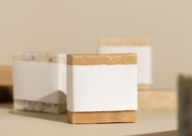 Beige soap bars with blank label on light beige close up hard shadows packaging mockup