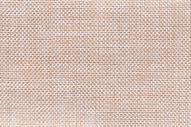 Beige textile background closeup. Structure of the fabric macro