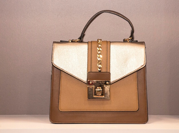 Beige women's bag with gold clasp