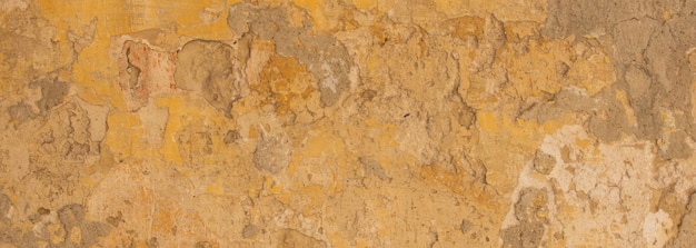 Beige colore giallo verniciato e sbiadito parete texture grunge sfondo