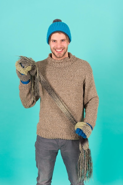 Being in playful mood. men knitted cloth and accessory. male blue background. poor homeless man. cheerful man feeling cold in winter. no flu. winter weather forecast. guy wear warm clothes.