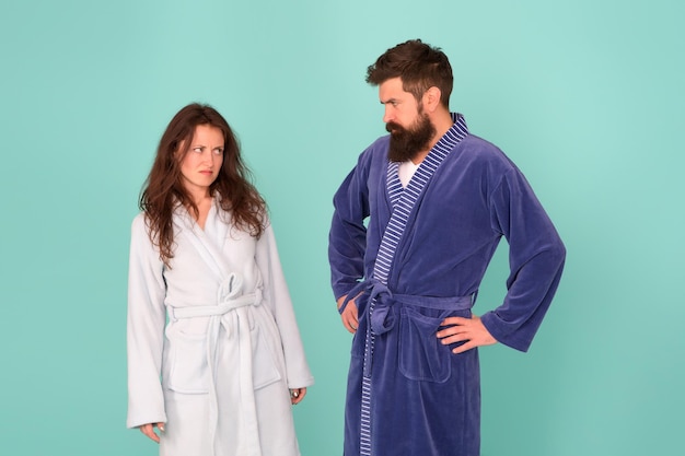 Being sad is a choice. couple in love look sad. sad woman and\
man wear bathrobes blue background. family conflict. depression and\
stress. bedtime or morning routine. health care. unhappy and\
sad.