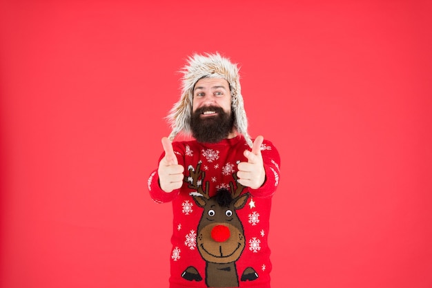 Photo being successful. wear warm clothes. happy hipster with beard in favorite sweater. knitwear and fur accessory. new year holidays. merry christmas. male winter fashion. feel cosy any weather.