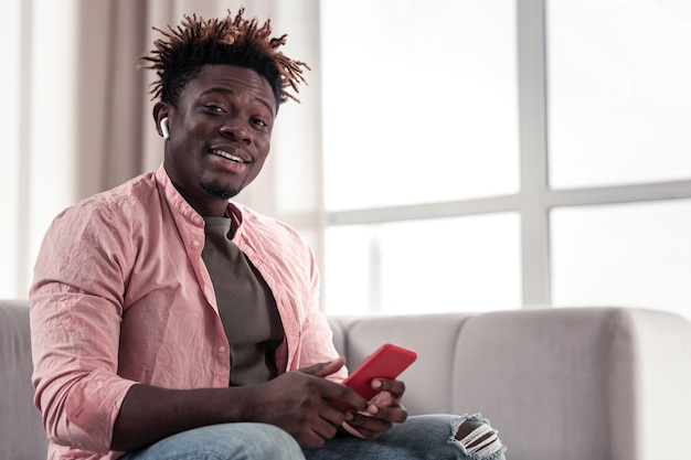 Being surprised. Delighted man expressing positivity while answering on message