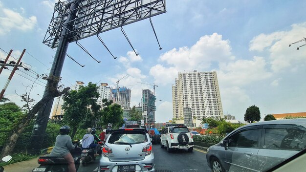 Bekasi Indonesia on July 20 2023 Vehicles in the form of motorbikes and cars are crossing Jalan Ahmad Yani Bekasi