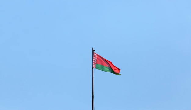 Belarusian state flag on a blue sky