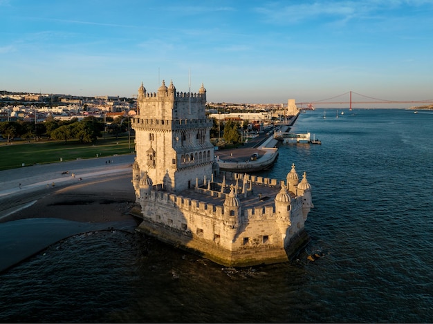 Belem tower on the bank of the tagus river at sunset lisbon portugal