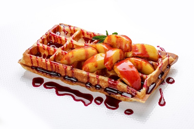 Belgian sweet waffles on a white background Stuffed with peaches and syrup