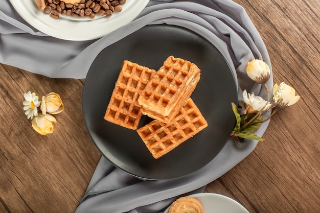 Belgian waffles on a black saucer