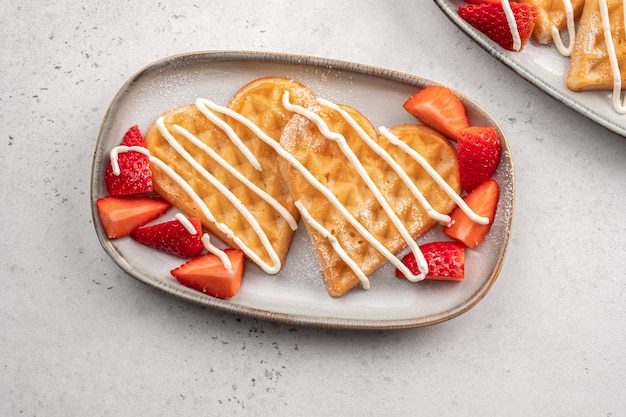 Belgian waffles in shape of heart with strawberries