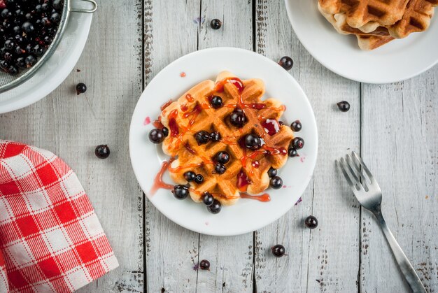 Foto waffle belgi e bacche estive e barattolo di ribes