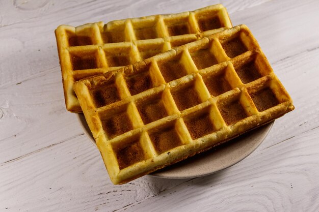 Belgian waffles on white wooden table