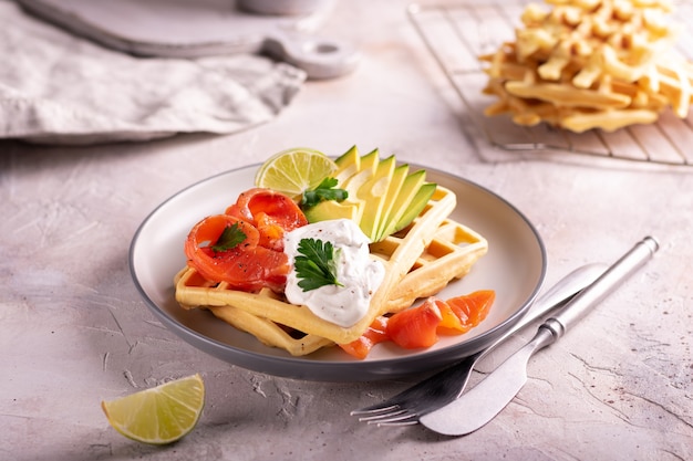 Belgian waffles with avocado and salmon for breakfast