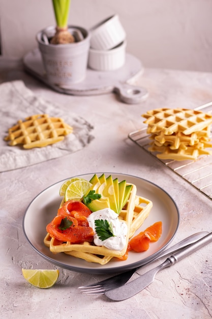 Belgian waffles with avocado and salmon for breakfast