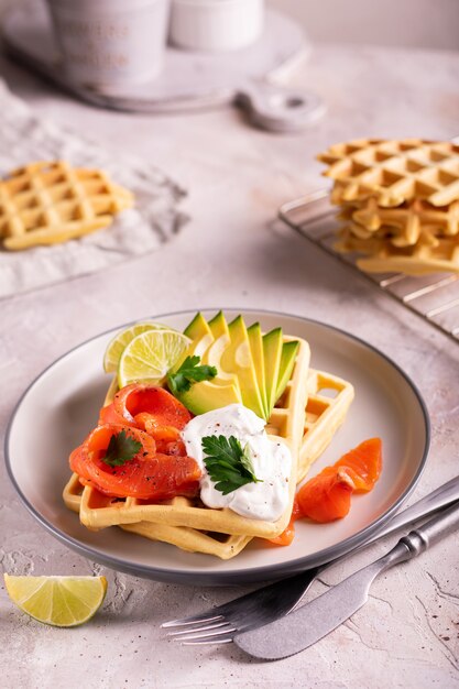 Belgian waffles with avocado and salmon for breakfast