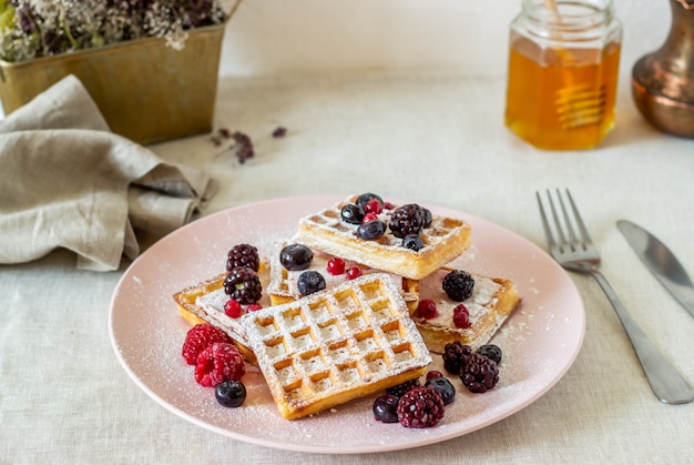 Belgian waffles with berries and honey