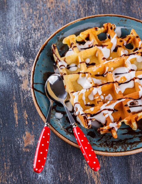 Belgian waffles with fresh berries and chocolate sauce.