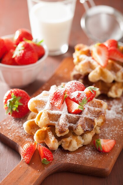 Belgian waffles with icing sugar and strawberry