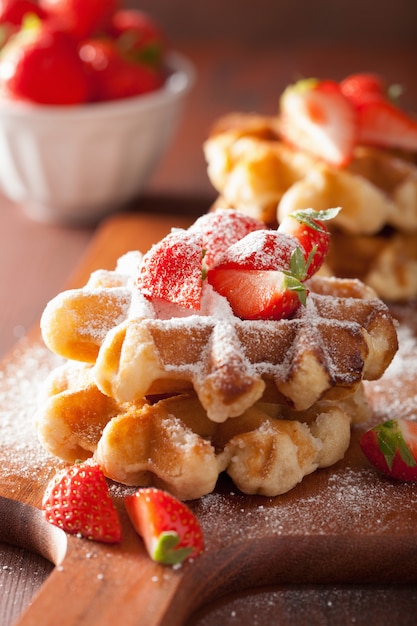 Belgian waffles with icing sugar and strawberry