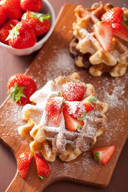 Belgian waffles with icing sugar and strawberry