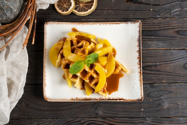 Belgian waffles with peach and caramel.