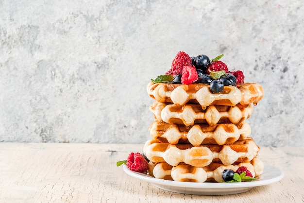 Belgian waffles with raspberries, blueberries and syrup