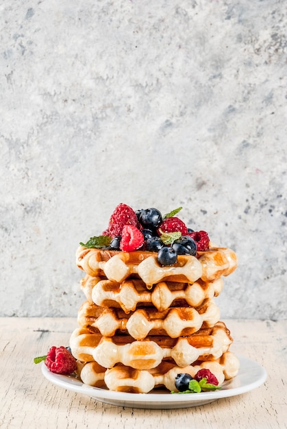 Belgian waffles with raspberries, blueberries and syrup