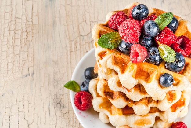 Belgian waffles with raspberries, blueberries and syrup