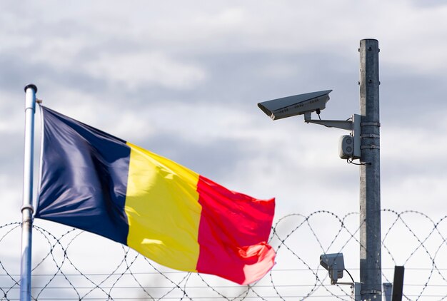 Belgium border, embassy, surveillance camera, barbed wire and Flag of Belgium, concept picture