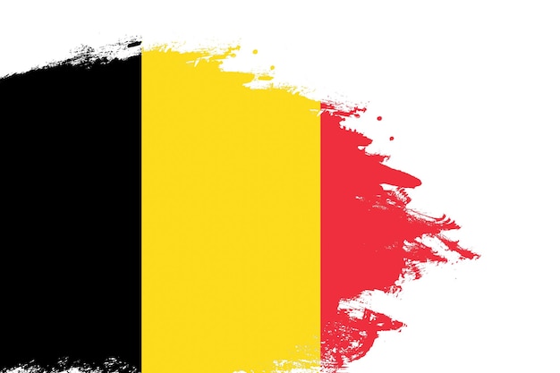 Photo belgium flag on a stained stroke brush painted isolated white background with copy space