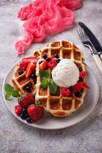 Belgium waffles with berries and ice cream