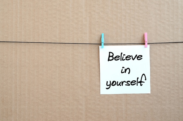 Believe in yourself. Note is written on a white sticker that hangs 