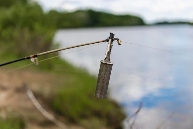 Premium Photo  Bell on a fishing spinning rod fishing feeder on the river  blurred background