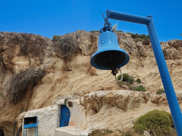 A bell hangs from a hill in the village of agia pelagia.