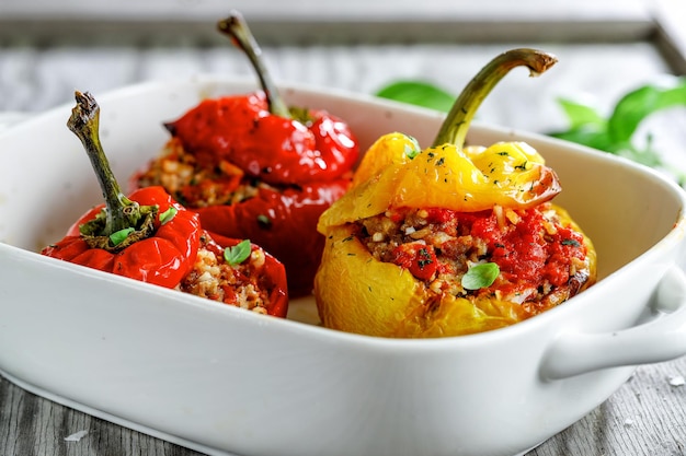 Bell pepper stuffed filled with minced meat and rice served in bowl. Closeup