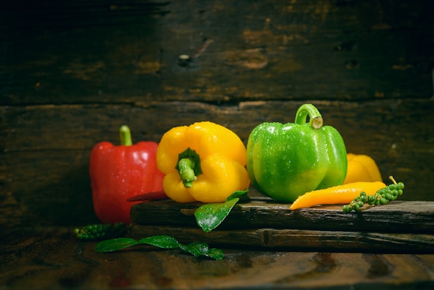 Bell pepper with vegetables on the old wooden floor