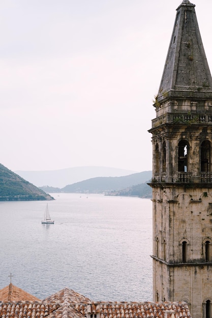 Bell tower of the church of st nicholas on the background of the sea montenegro