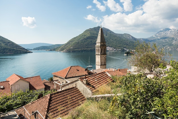 Bell tower of St Nicholas Church with a view on a Kotor Bay in Perast Montenegro