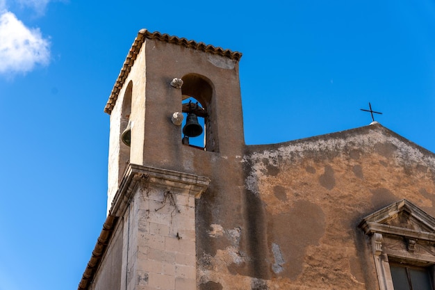 A bell tower with a bell hanging from it