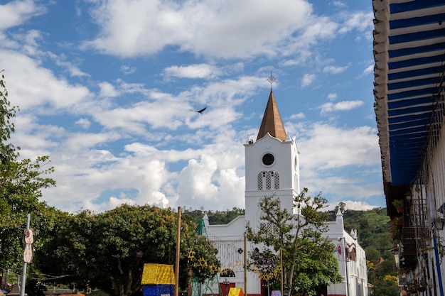 Bell tower with a white tower in a town in Colombia