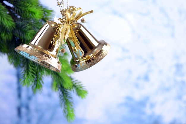 Bells with Christmas decoration on light background