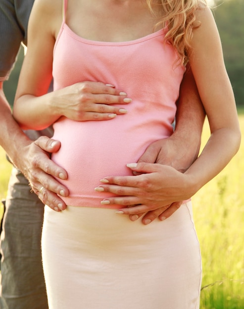 Belly Loving pregnant couple in nature