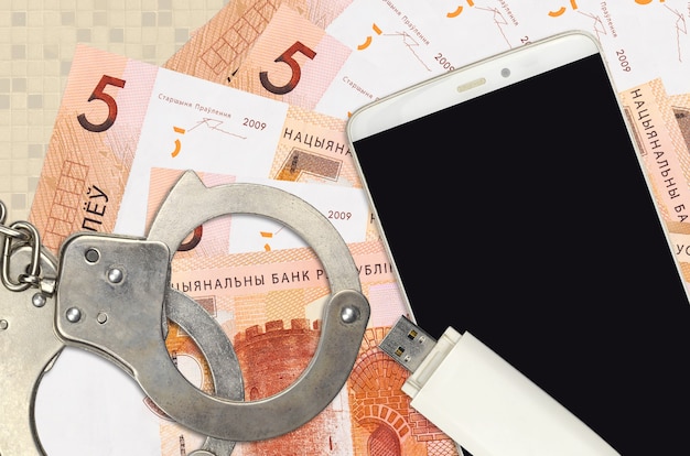 Belorussian rubles bills and smartphone with police handcuffs